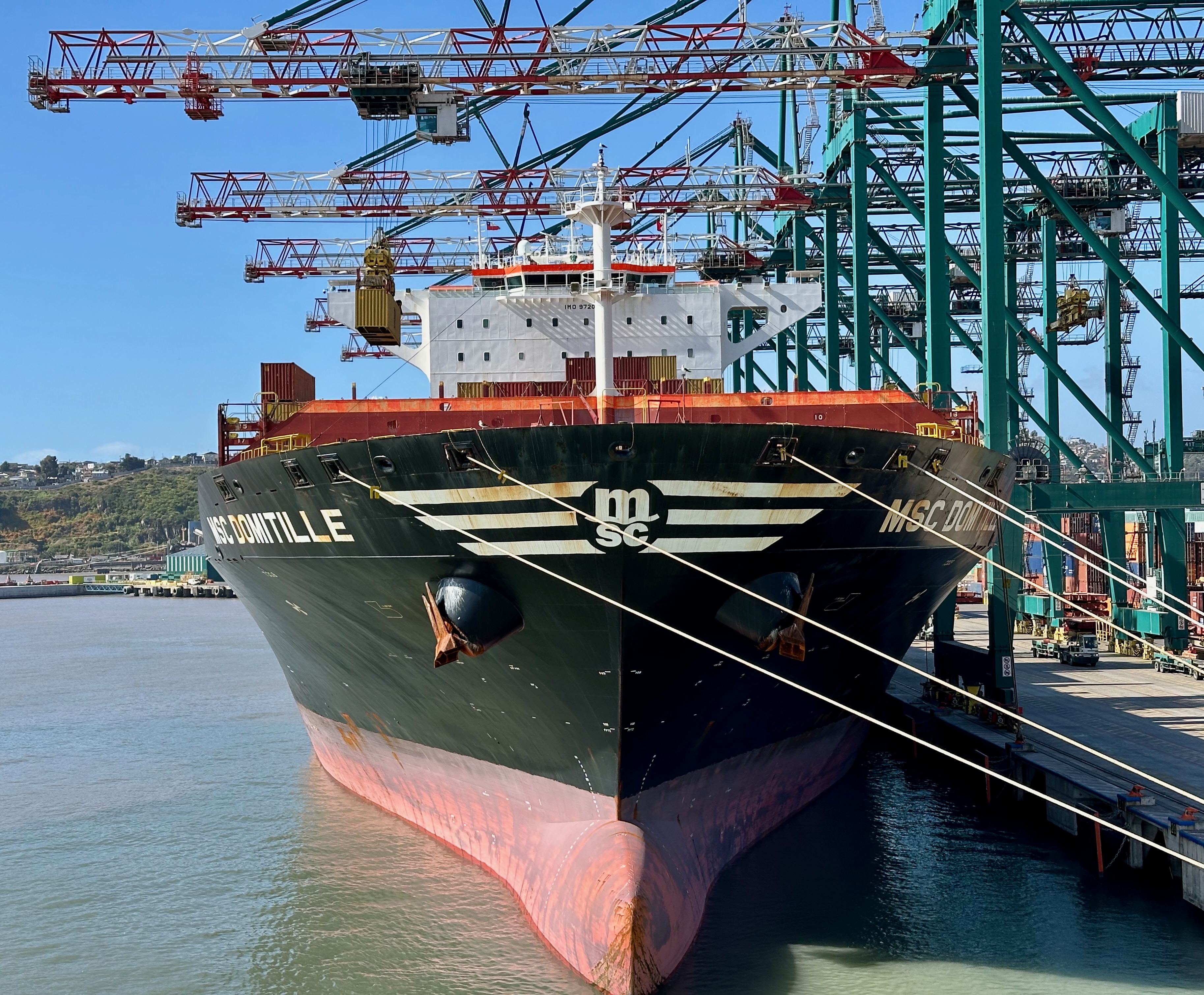Image of a near cargo ship being loaded with containers